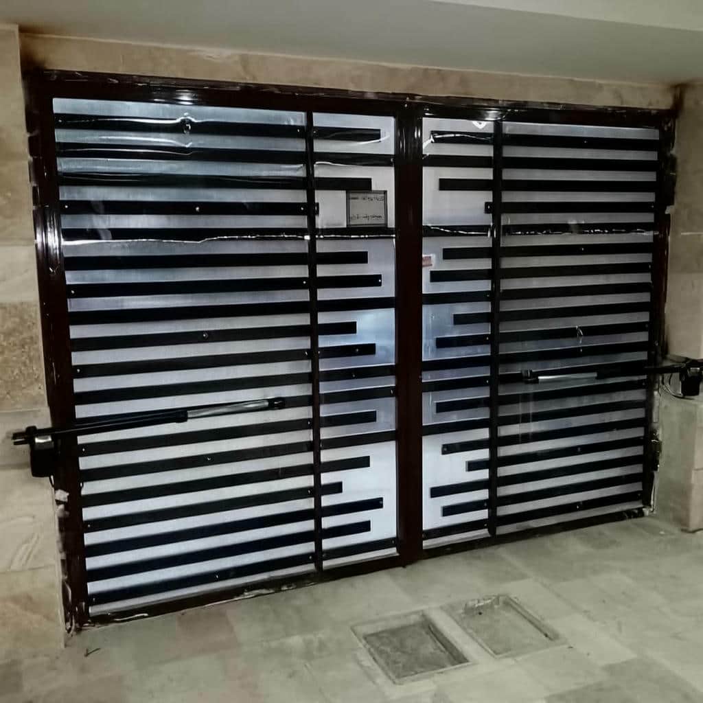 تعمیر درب پارکینگ جک دار بازویی و تنظیم مدار فرمان